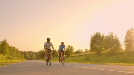 Tracking-shot-of-a-group-of-cyclists-on-country-road.-Fully-released-for-commercial-use.